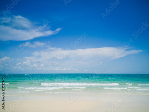 The beach and the sea are fascinating on a beautiful blue day. © Takorn