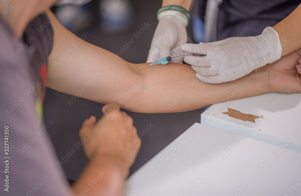 Woman doctor vaccinations to patients using the syringe.Doctor vaccinating women in hospital. Are treated by the use of sterile injectable upper arm. injection. Clipping path added.