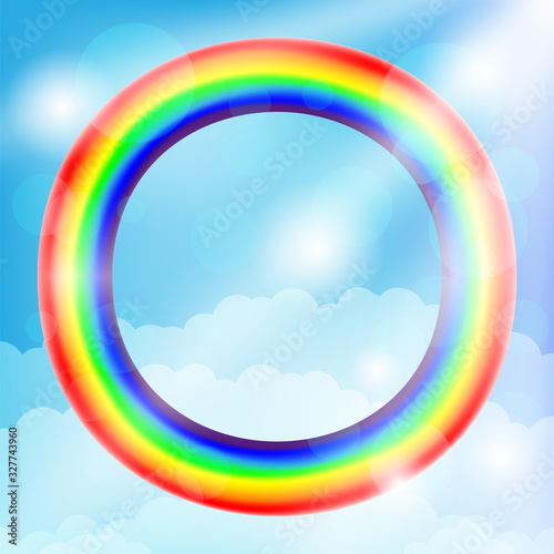 Round rainbow frame and clouds in the blue sky.
