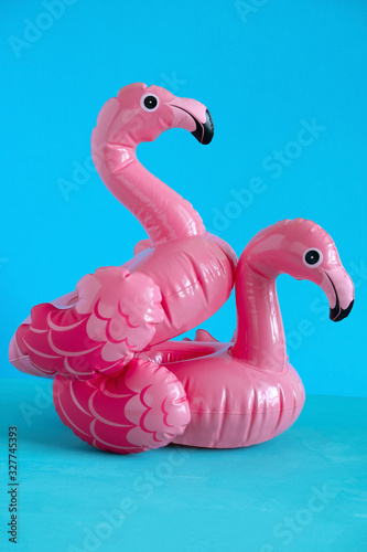 Fototapeta Naklejka Na Ścianę i Meble -  couple of inflatable pink flamingo on blue background
