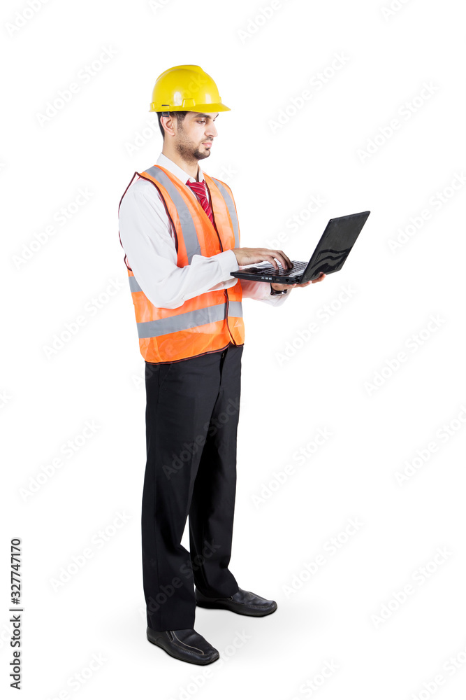 Young contractor working with laptop