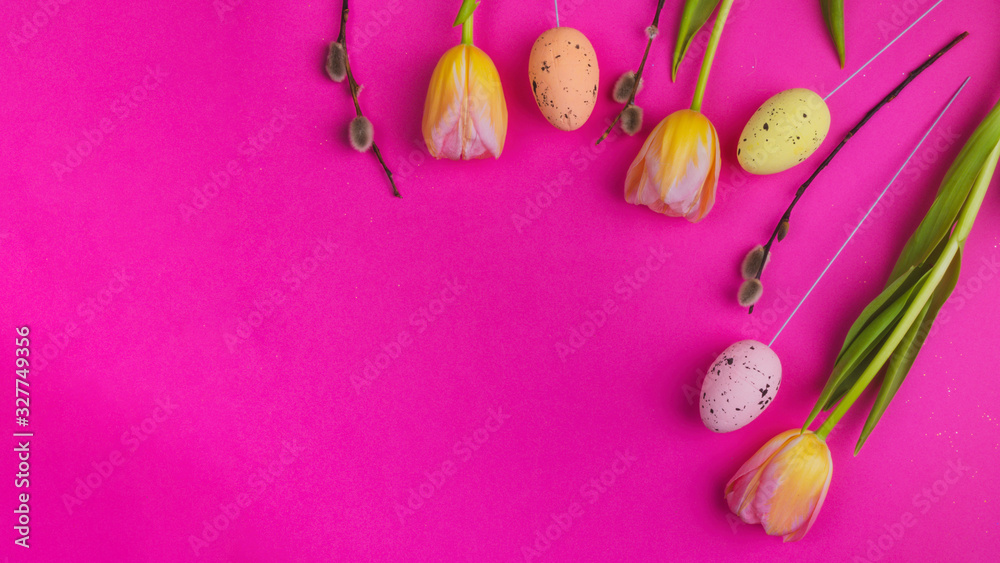 Tulips willow and eggs on pink background.