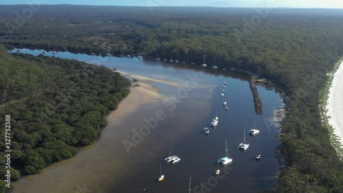 Aerial drone view of boats and yachts moored on Currambene Creek at Huskisson, Jervis Bay on the New South Wales South Coast, Australia, on a bright sunny day    photo