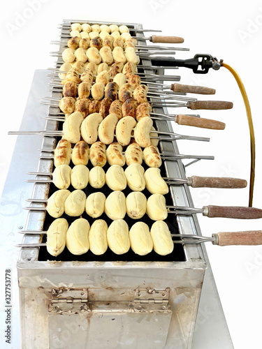 Wallpaper Mural Banana grilled on a grill isolated on white background.cultivated banana fruit on a hot charcoal grill in Thailand outdoor market,It's a traditional Thai cuisine food gourmet Torontodigital.ca