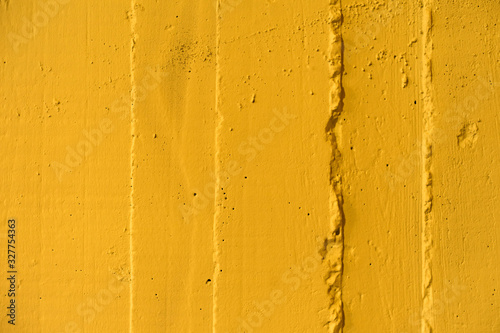Yellow concrete wall texture with interesting surface.Close-up.