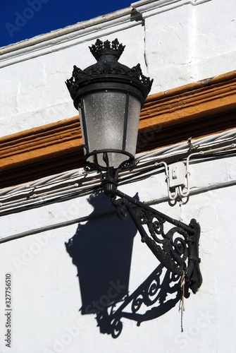 Ornate wall light attached to a town building, Ecija, Spain.