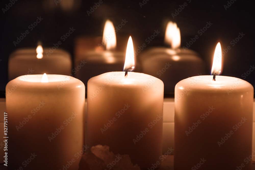 Burning candles on the windowsill. Cozy summer evening at home Burning candles on the windowsill. Cozy summer evening at home
