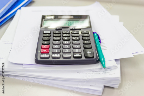calculator with business paper on table in work office, concepts business and cost and financial planning