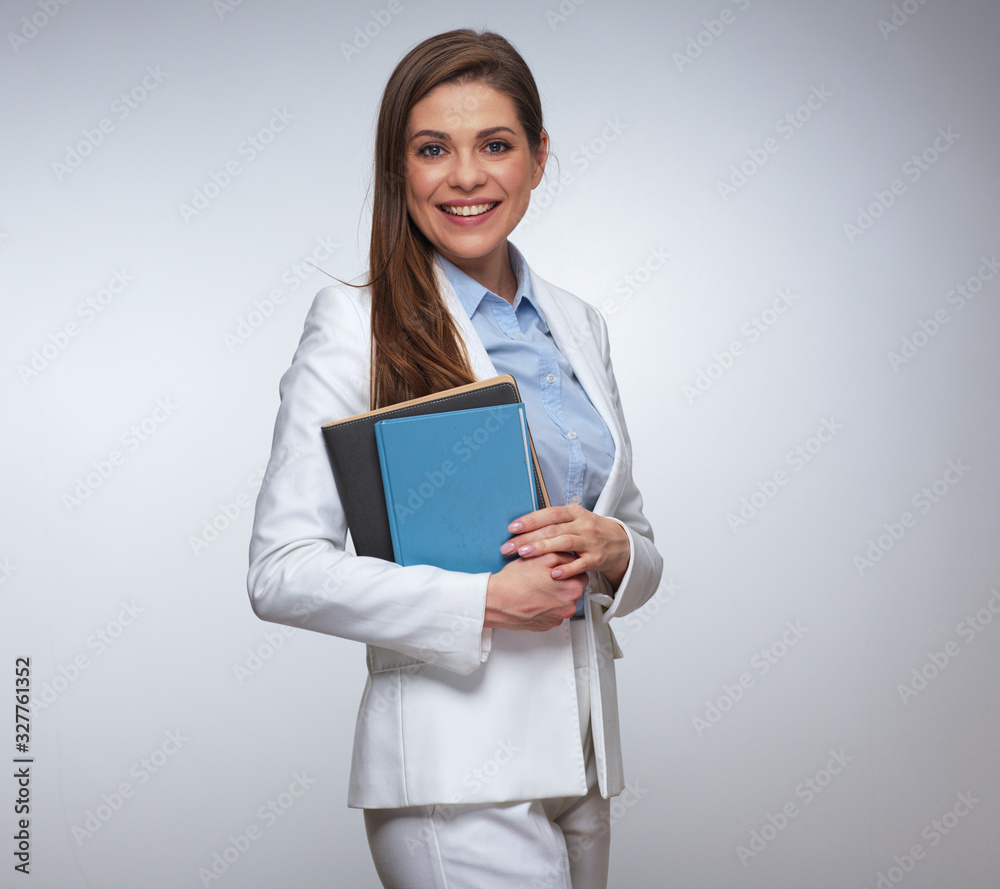 Smiling business woman in white suit holding blue book. Smiling business woman in white suit holding blue book.