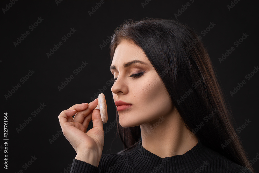 Portrait of beautiful woman with powder puff. Girl applying makeup. Portrait of beautiful woman with powder puff. Girl applying makeup.