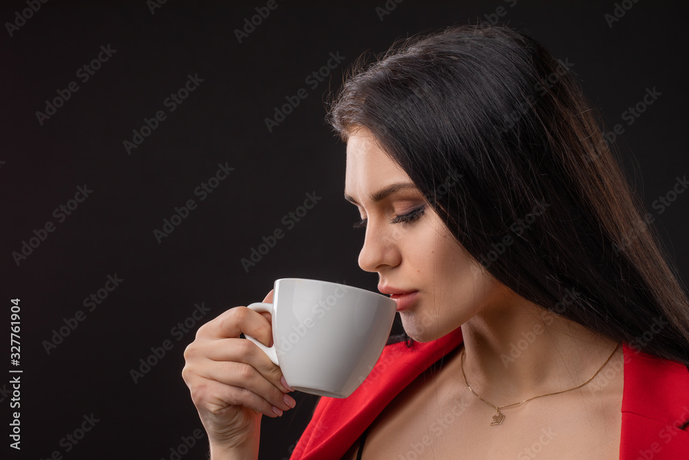 Beautiful happy woman drinking a cup of coffee Beautiful happy woman drinking a cup of coffee