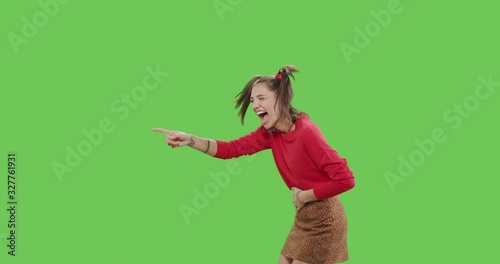 Young cheerful woman pointing to side and upwards photo