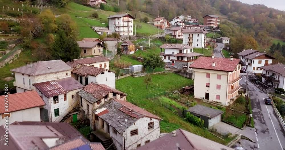 Charming Old Mountain Town Of Valsassina Crandola Italy And Colorful Forest Landscape In Autumn - aerial shot Charming Old Mountain Town Of Valsassina Crandola Italy And Colorful Forest Landscape In Autumn - aerial shot