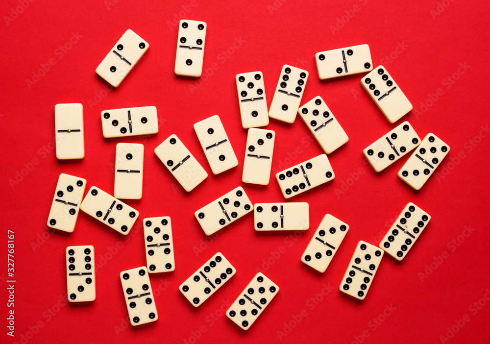 Playing dominoes on a red table. flat lay background. Playing dominoes on a red table. flat lay background.