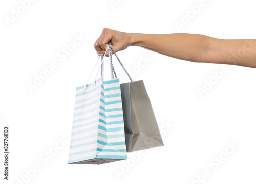 Paper craft bag, eco packaging in a female hand, isolated on white background, with place for text.
