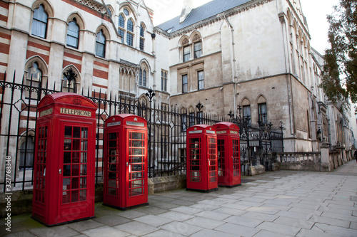 Wallpaper Mural a line of four old red British telephone boxes in London, England. Torontodigital.ca