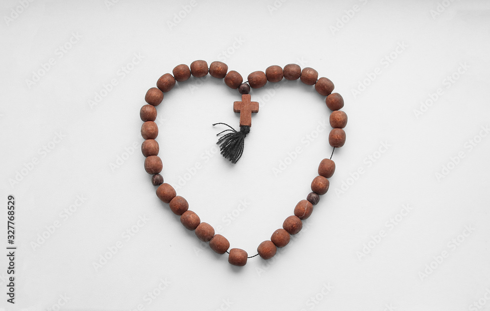 Christian beads made of wood with a cross. Christian beads made of wood with a cross.
