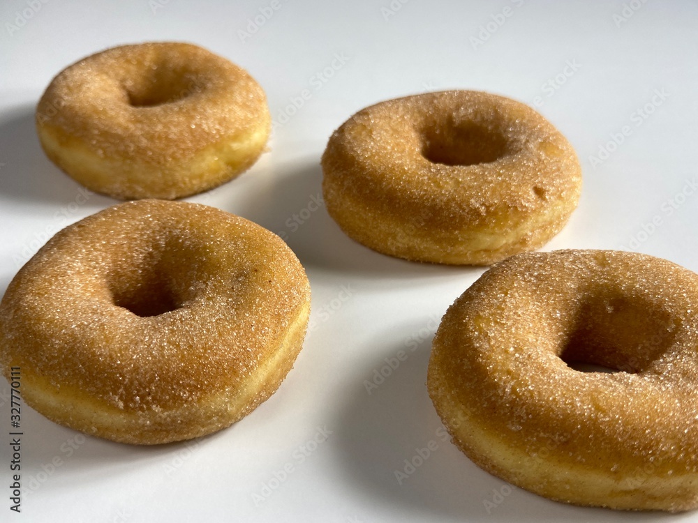 Donuts with cinnamon sugar-coated, on a white background