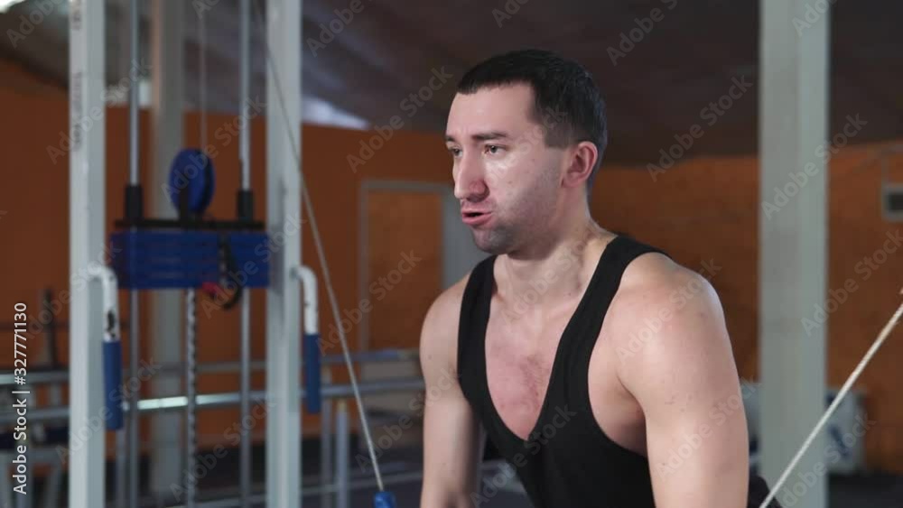 Guy bodybuilder in the gym, working with a bar, to be tightened, improving triceps, large pectoral muscle and anterior deltoid muscle. Concept love sports, go to the gym eat right slim body be healthy Guy bodybuilder in the gym, working with a bar, to be tightened, improving triceps, large pectoral muscle and anterior deltoid muscle. Concept love sports, go to the gym eat right slim body be healthy
