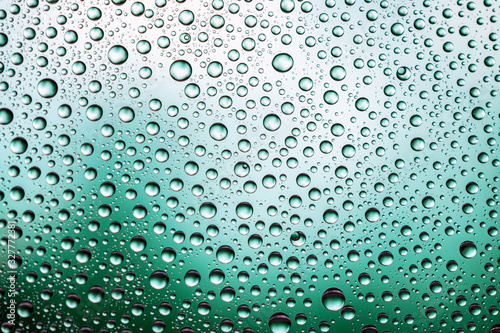 Water drops on window glass. Rain texture or wet pattern background.