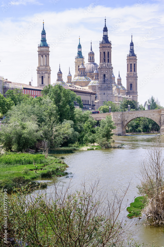 Nuestra Senora del Pilar Baroque cathedral with multi-colored domes, the famous statuette of the Virgin Mary and the frescoes of Francisco Goya.Stone Bridge on the Ebro River
