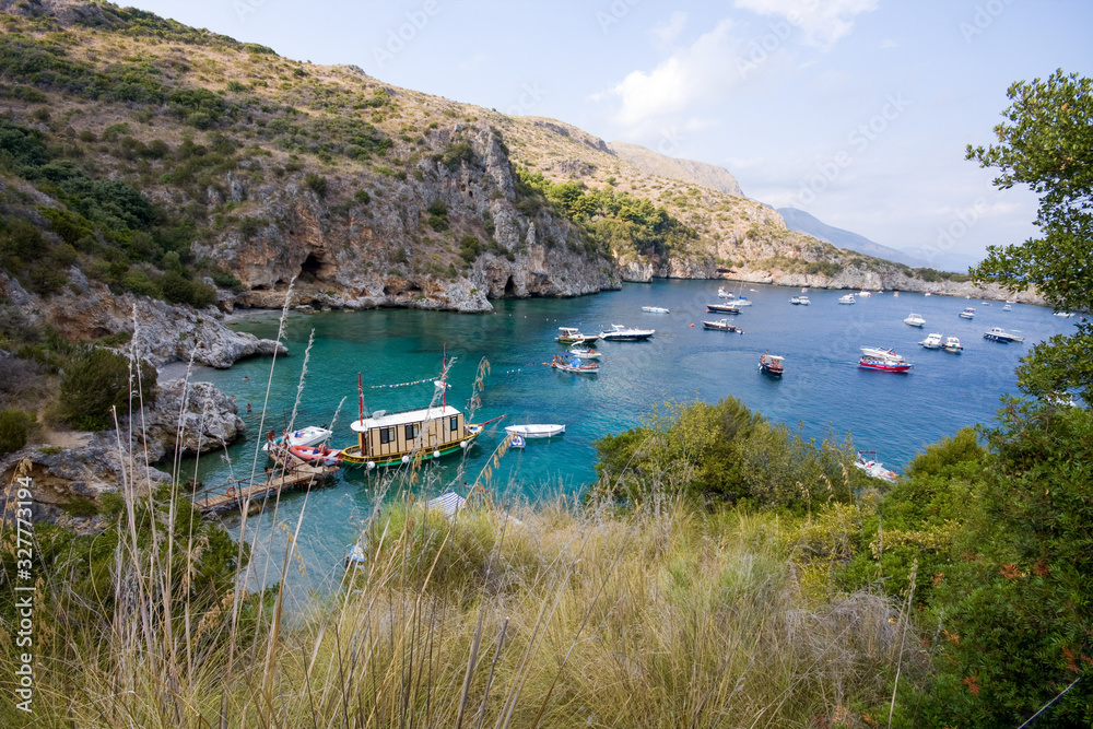 Obraz premium Infreschi Bay, Vessels moored in the bay Baia degli Infreschi on the Masseta coast of Cilento in Italy in summer