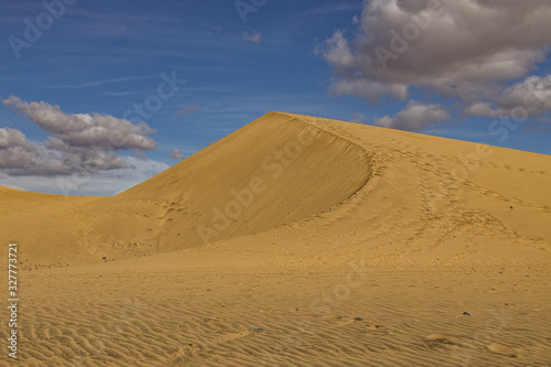 summer desert landscape on a warm sunny day from Maspalomas dunes on the Spanish island of Gran Canaria