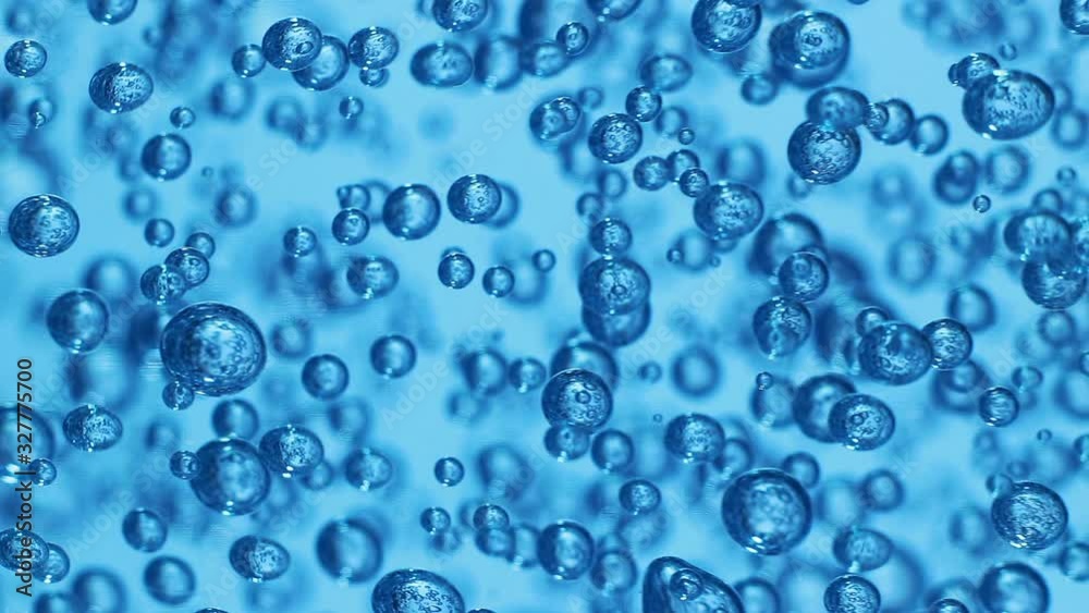 Macro shot of air bubbles in transparent gel, blue background. Movement of many spheres inside thick liquid Macro shot of air bubbles in transparent gel, blue background. Movement of many spheres inside thick liquid
