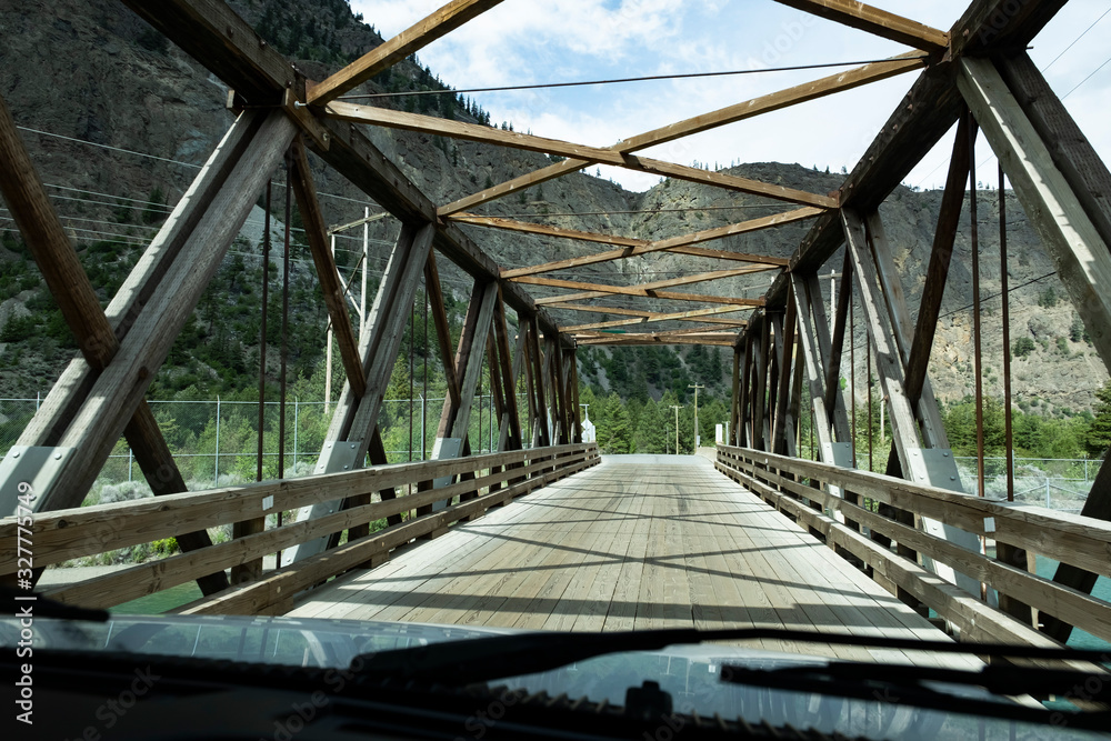 driving a camper over a wooden bridge in provincial park, British Columbia, Canada