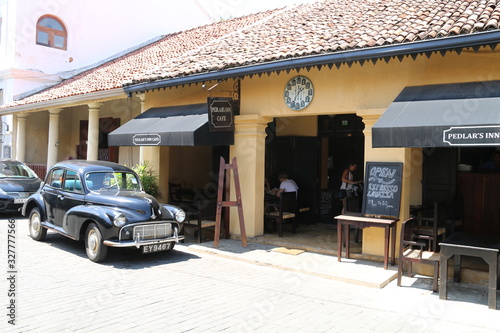 Old car parked in front of shop