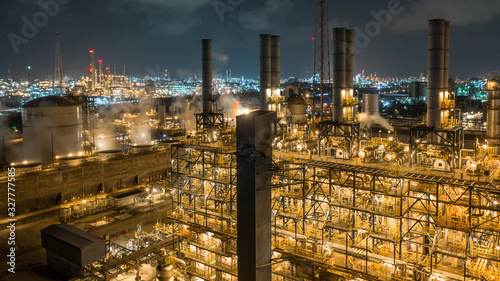 Aerial view industrial view at oil refinery plant form industry zone at night, Refinery plant or petrochemical factory industrial, Ecosystem and healthy environment ecology concept.