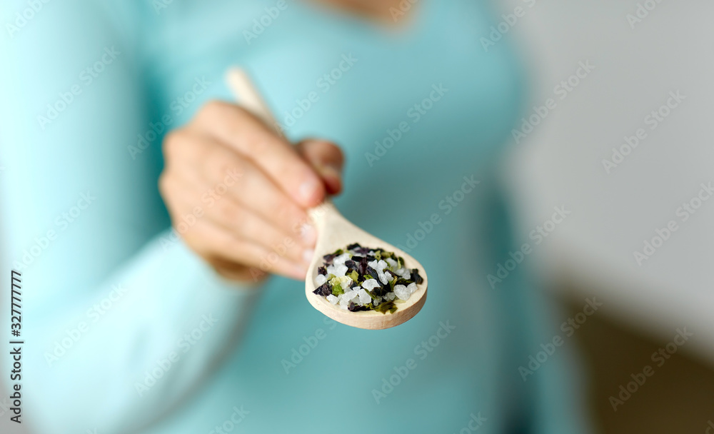 Φωτογραφία food cooking, culinary and eating concept - close up of woman with sea salt on w