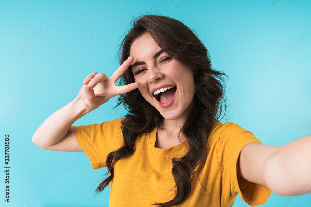 Cheery young pretty woman take a selfie by camera. Cheery young pretty woman take a selfie by camera.