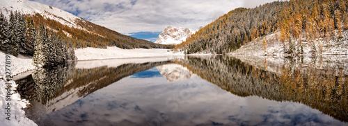 Winter panorama of Lake Calaita, in the background the Dolomites - Pale di San Martino