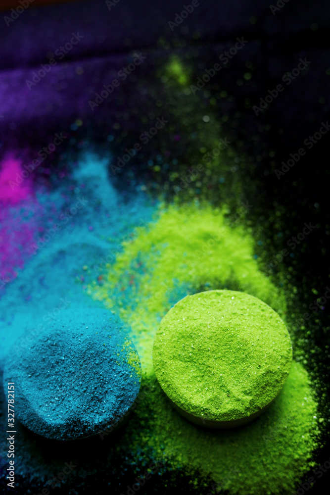 top view of colorful traditional holi powder in bowls isolated on dark background. Space for text. happy holi. Concept Indian color festival called Holi