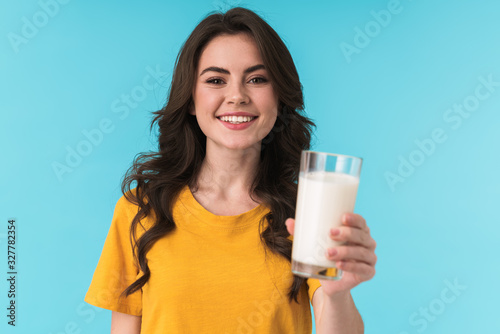 Positive optimistic young beautiful woman holding milk.