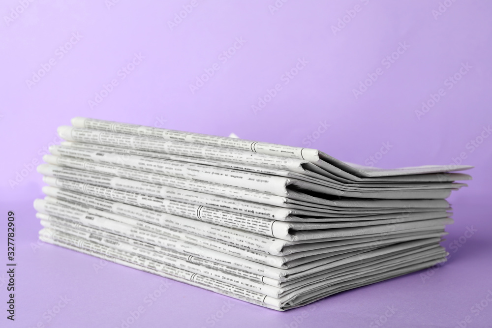 Stack of newspapers on light violet background. Journalist's work Stack of newspapers on light violet background. Journalist's work