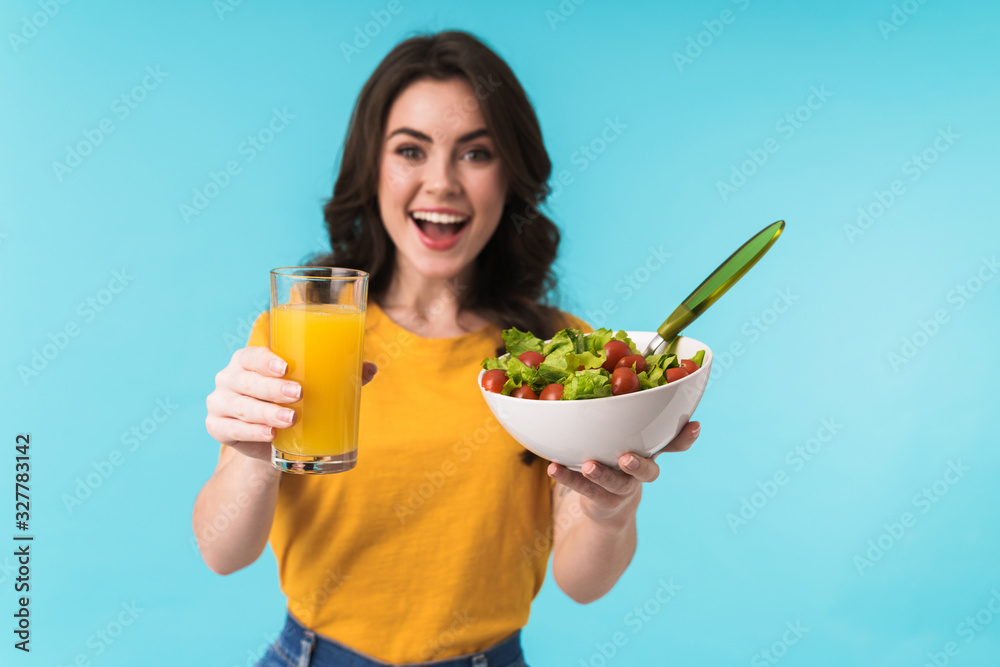 Woman posing isolated holding salad and juice. Woman posing isolated holding salad and juice.