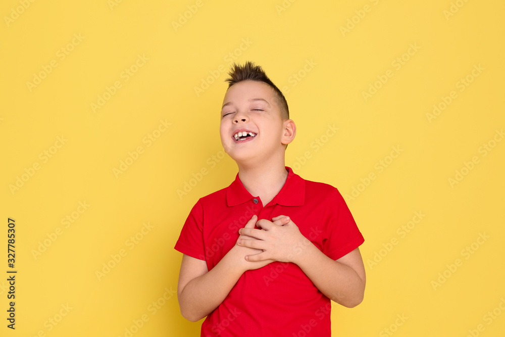 Portrait of emotional little boy on yellow background Portrait of emotional little boy on yellow background