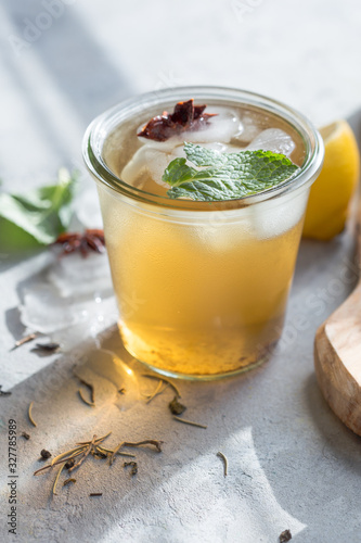 Cold Lemon green tea in glass with anise ice. Heathy summer probiotic drink