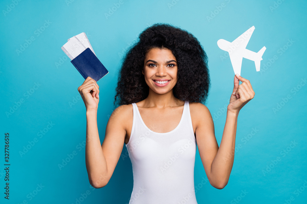 Close-up portrait of her she nice attractive lovely cheerful cheery wavy-haired girl holding in hands plane paper form passport ticket isolated on bright vivid shine vibrant blue color background Close-up portrait of her she nice attractive lovely cheerful cheery wavy-haired girl holding in hands plane paper form passport ticket isolated on bright vivid shine vibrant blue color background
