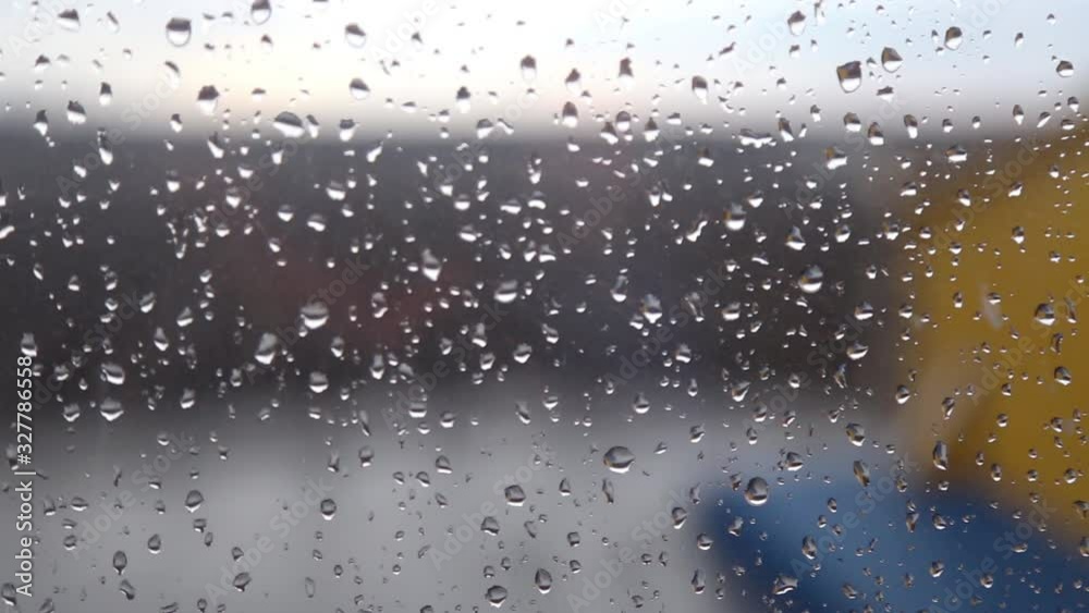 Drops of rain on blue glass background / drops on glass after rain Drops of rain on blue glass background / drops on glass after rain