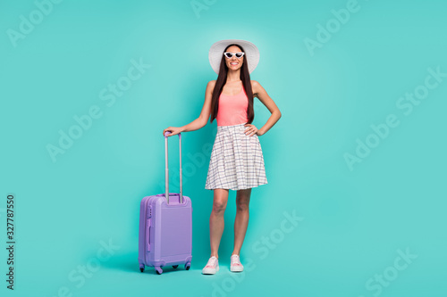 Luxury resort wait me. Full body photo positive cheerful girl ready travel summer weekends hold first-class suitcase wear sunglass sunhat singlet footwear isolated turquoise color background