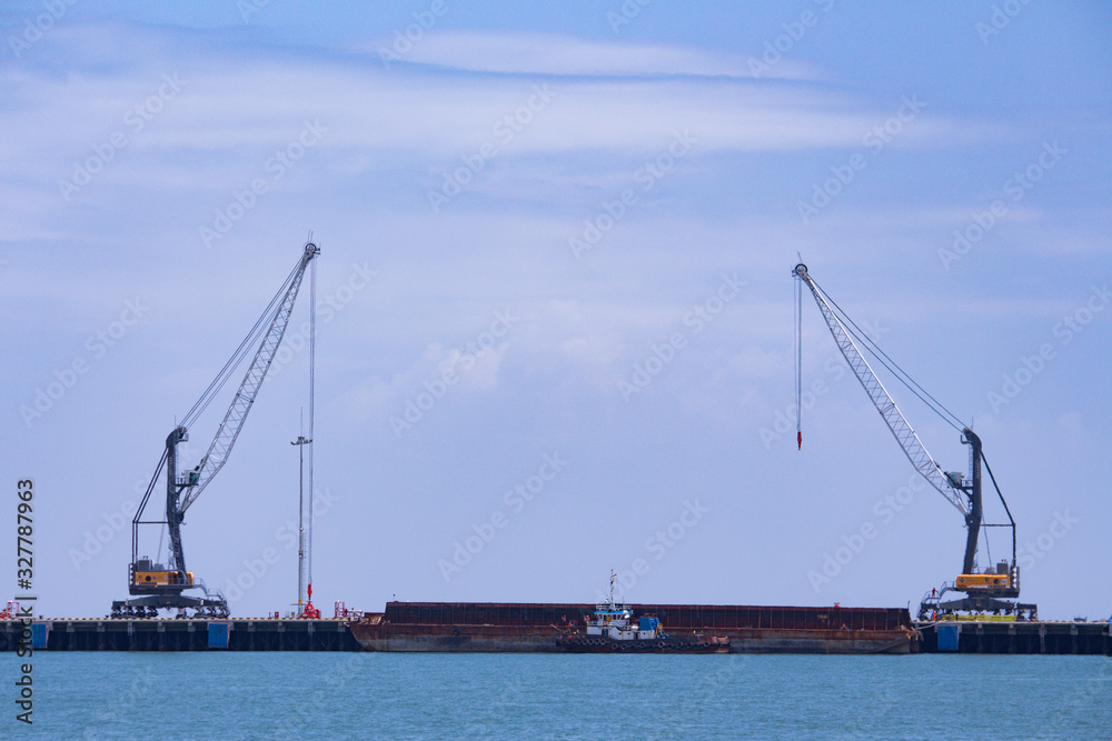 2 units of Harbor Mobile Crane (HMC) are being loaded onto barges