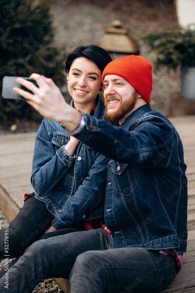 Young stylish couple in love takes a selfie outdoors Young stylish couple in love takes a selfie outdoors