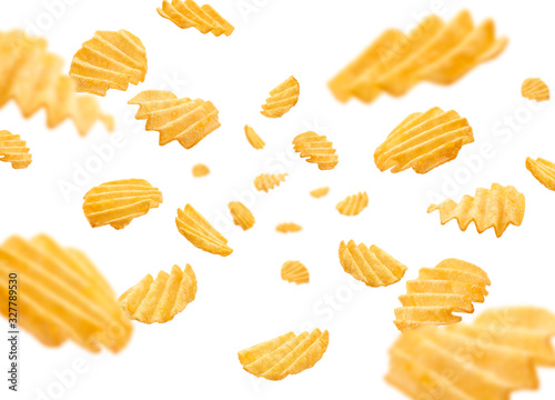 Fluted potato chips levitate on a white background