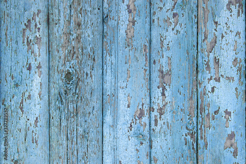 Crackled paint on old light blue wood planks.
