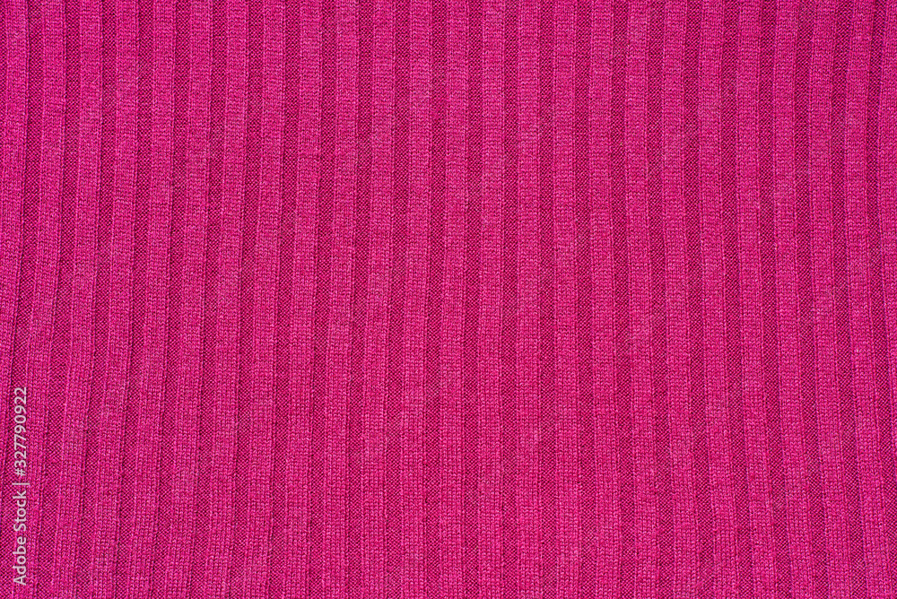 Fragment of a red knitted fabric texture with vertical stripes Fragment of a red knitted fabric texture with vertical stripes