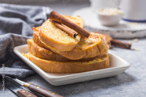 Traditional homemade Spanish torrijas on wooden background. Easter dessert.