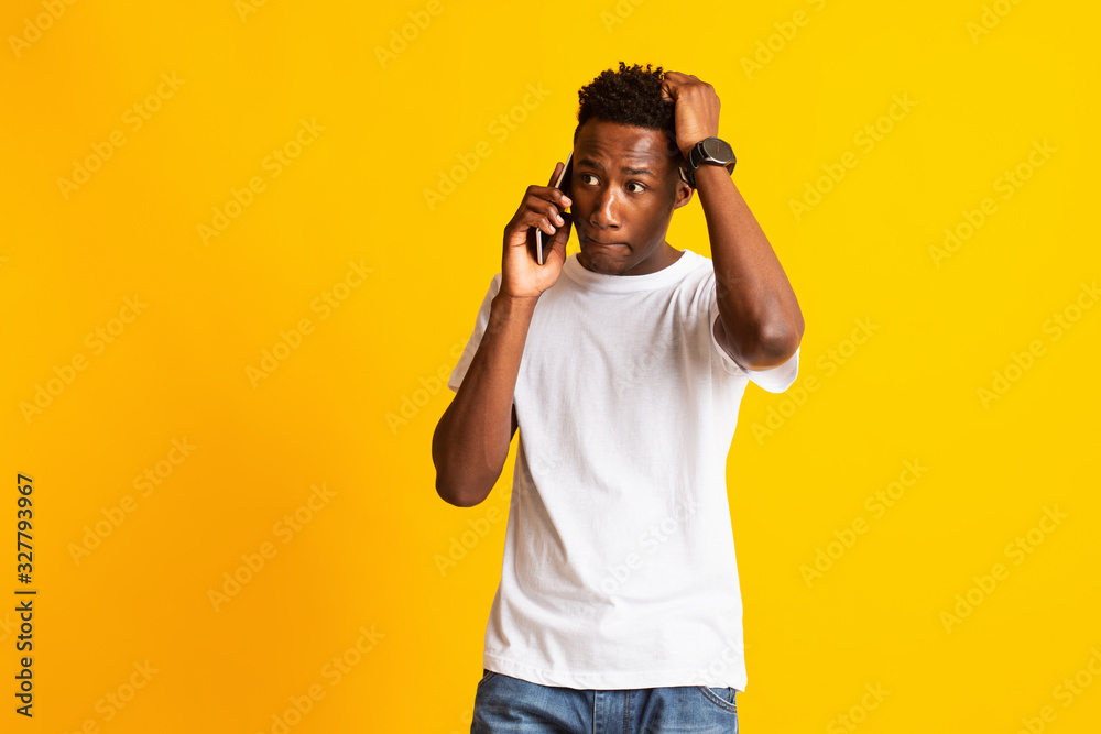 Shocked young african man talking by cellphone Shocked young african man talking by cellphone